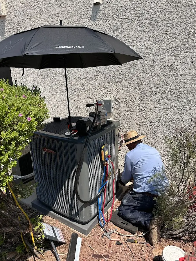 HVAC technician performing outdoor AC maintenance in Marlborough